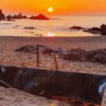 Un grup de joves tomba el monòlit d’acer inoxidable que va aparèixer a la platja de Sa Conca de S’Agaró