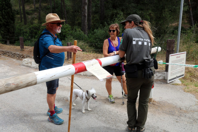 Una agent rural informant una parella d'excursionistes que no es pot entrar al parc natural del Montgrí arran de l'elevat risc d'incendi i l'activació del nivell 3 del Pla Alfa Data de publicació: dijous 07 de juliol del 2022, 13:08 Localització: L'Estartit Autor: Xavier Pi